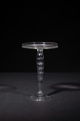 a close up of a clear glass table with a black background