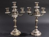 a pair of silver plated candelabs on stands