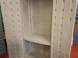 a white cabinet that has a shelf in it