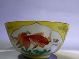 a bowl with a gold fish on it on a table