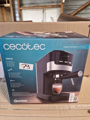 the box is open to show the contents of a coffee machine