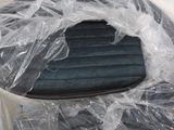 a plastic bag on top of a chair that is wrapped in plastic