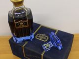 a bottle of liquor sitting on top of a blue box