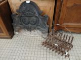a fireplace with a bunch of old tools on the floor