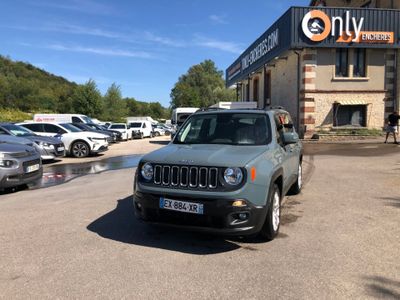 a jeep parked in front of a building in a parking lot