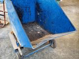 a blue wheelbarrow that is sitting in a warehouse