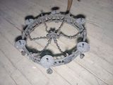 a picture of a circular metal object on a wooden floor