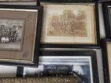 a lot of framed pictures on the wall of this room