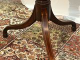 a small table with a marble top on a rug