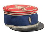 a red and blue hat with a gold emblem on it