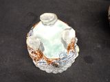 a small bowl with a candle inside of it on a table