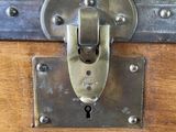 a small wooden trunk with a lock on it