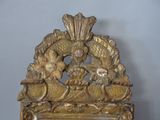 a gold clock with a bird on top of it