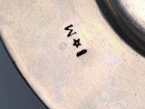 an antique silver plate with the word i am written on it