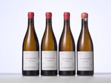 three bottles of wine are lined up on a table