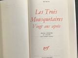 an open book with red writing on it sitting on a table