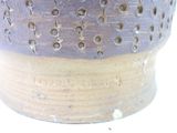 a close up of a vase with holes in it
