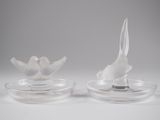 pair of clear glass birds on a clear plate on a white background