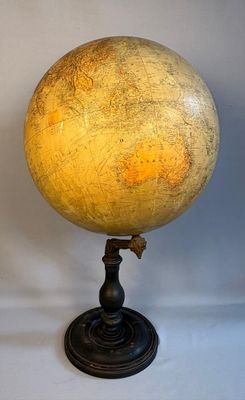 an image of a yellow and black globe on a black stand