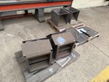 several pieces of metal sitting on a pallet in a warehouse