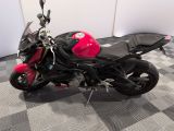a black and red motorcycle parked on a checkered floor