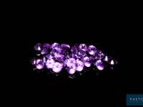 a bunch of purple gems sitting on top of a black surface