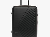 an image of a black suitcase on wheels on a white background