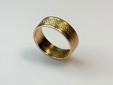 an image of a gold ring on a white surface