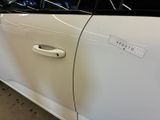 a white car that has a sticker on the door