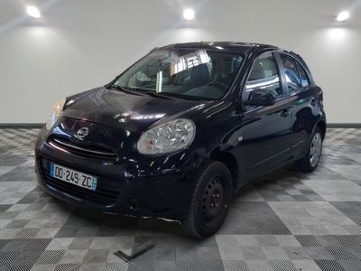 a picture of a small black car parked in a garage