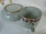 two cups and a saucer sitting on a table
