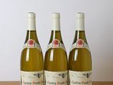 three bottles of wine sitting on a wooden table next to a bottle of wine
