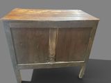 a small wooden cabinet with a door on top of it