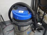 a blue and silver vacuum sitting on top of a table