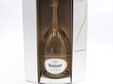 a bottle of wine in a box on a white surface