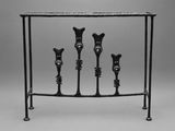 a black and white photo of a table with four legs