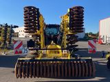 a picture of a tractor and other equipment in a parking lot