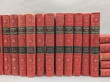 several red books are stacked on top of each other on a table