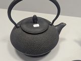 three teapots that are sitting on a table