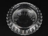 a clear glass bowl on a black surface