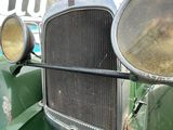 a close up of a car with a grill and a mirror