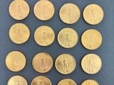 a close up of a bunch of gold coins on a table