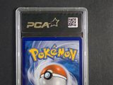 the pokemon card is in a plastic case on a black surface
