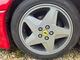 a close up of a tire on a red sports car