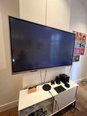 a flat screen tv mounted on a wall in a room