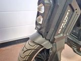 a close up of a motorcycle parked in front of a garage door