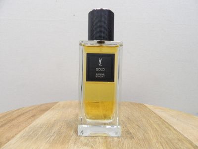 an image of a bottle of perfume sitting on top of a wooden table