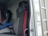 a white truck with a red seat and steering wheel
