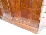 a large wooden cabinet with a door on top of it