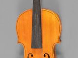 an old violin with a bow on a gray background